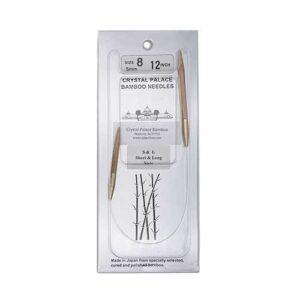 A size 8, 12 inch bamboo circular needle in its silver packaging