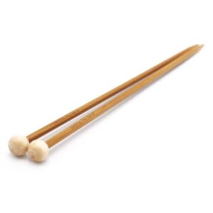 A pair of straight bamboo needles on a white background